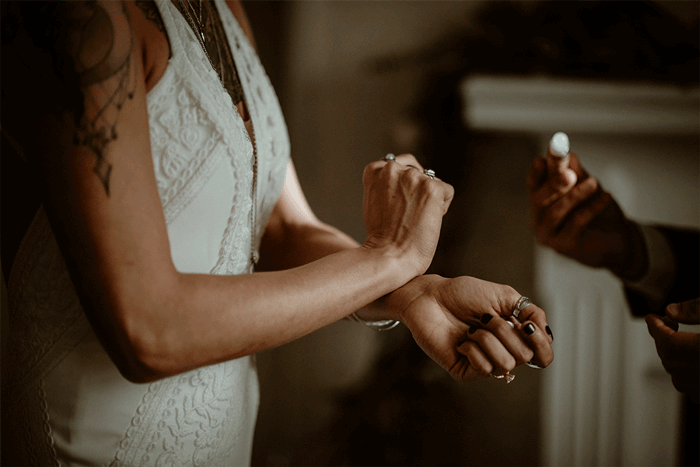 Moving gif of a bride applying roll-on perfume oil.