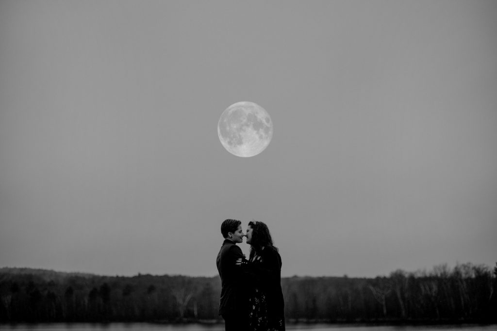 A couple under the full moon at their elopement.