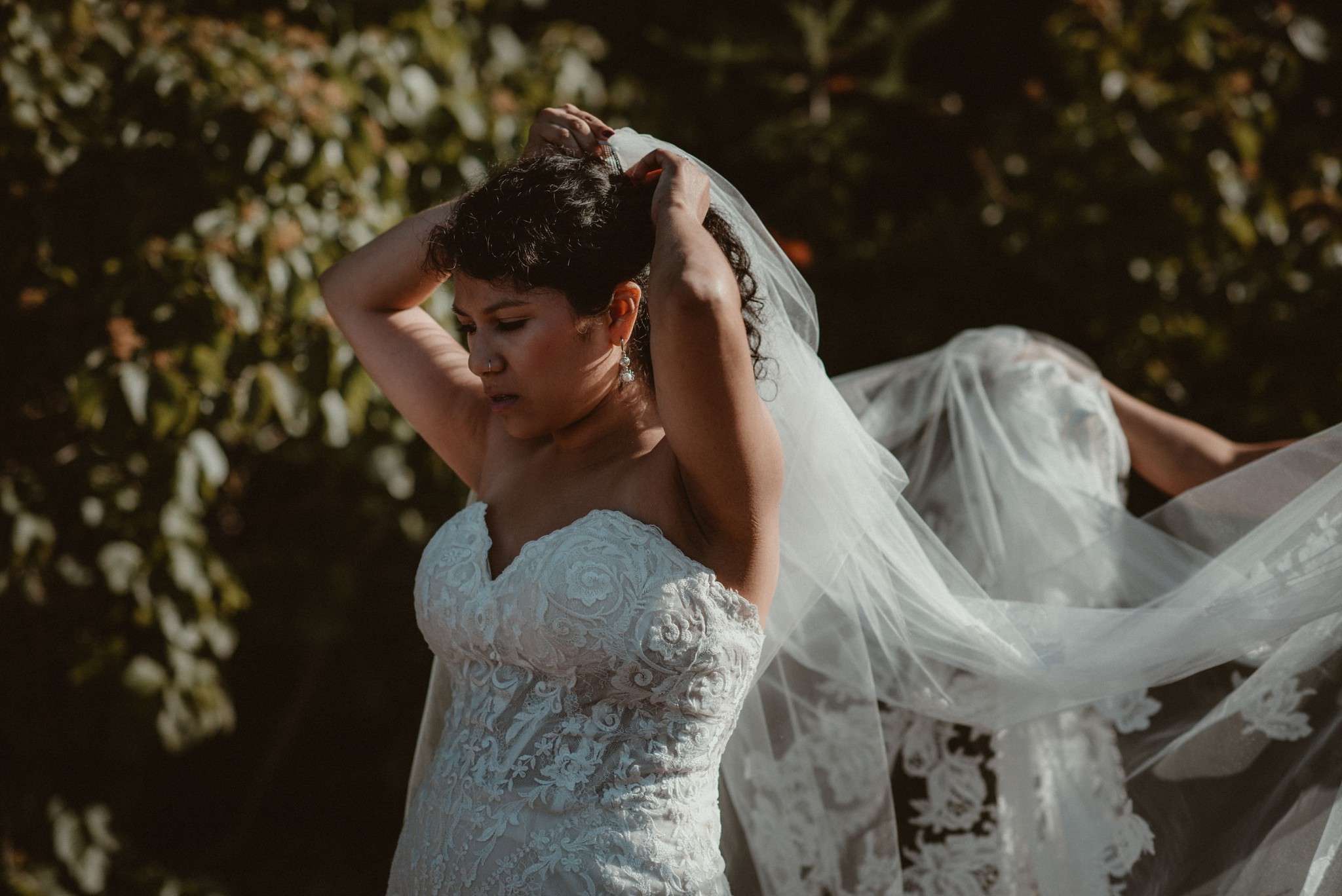 Bride putting on her veil