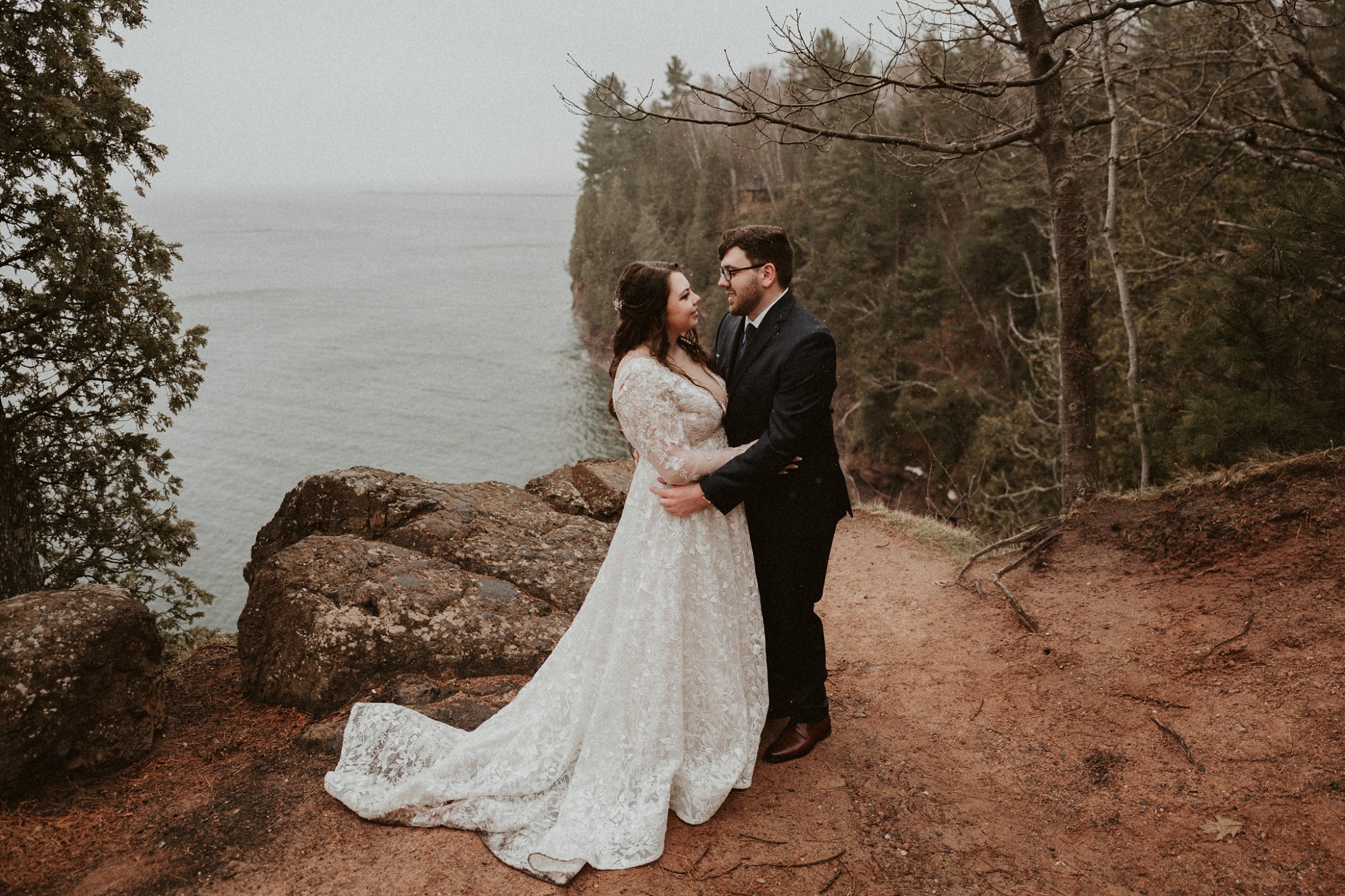 Bride and groom standing on Presque Isle in Marqutte at their "just us" elopement in Michigan.