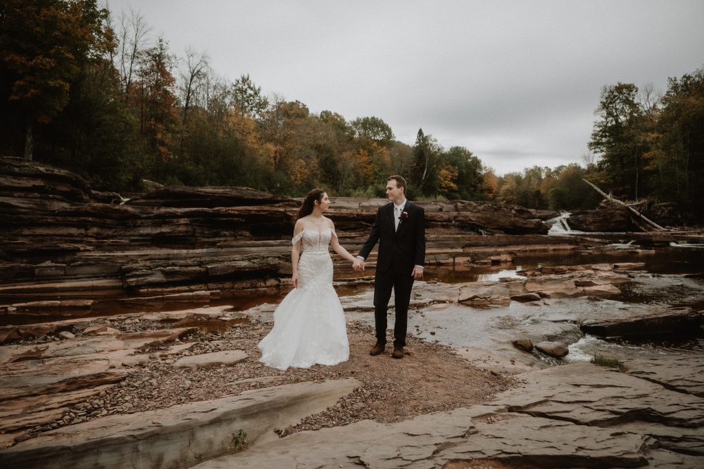 Wedding couple exploring Bonanza Falls near Silver City, Michigan during an Upper Peninsula elopement