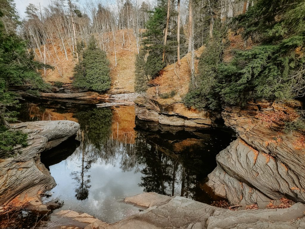 Waterfall and reflection along the Presque Isle Trail in the Porcupine Mountains