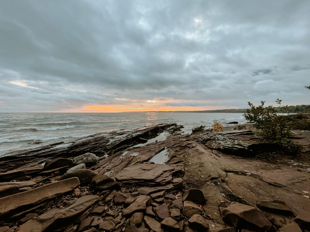 Rocky shoreline at Union Bay Beach in the Porcupine Mountains at sunrise