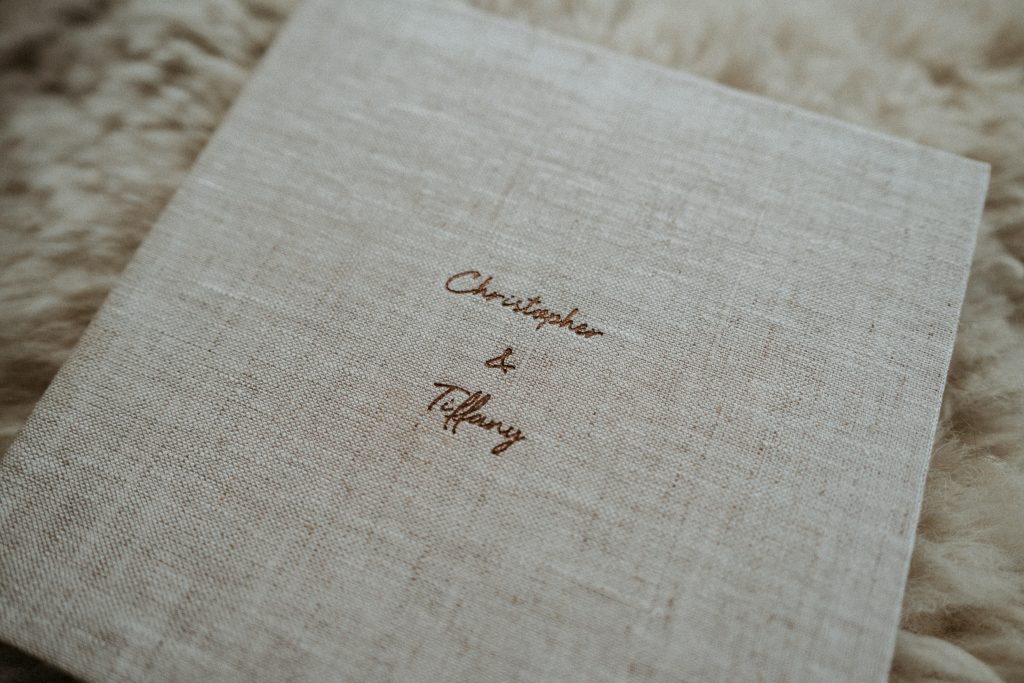 Lume Storybook, a natural linen hardcover photo book featuring images in a storytelling format and layflat pages. Cover detail.