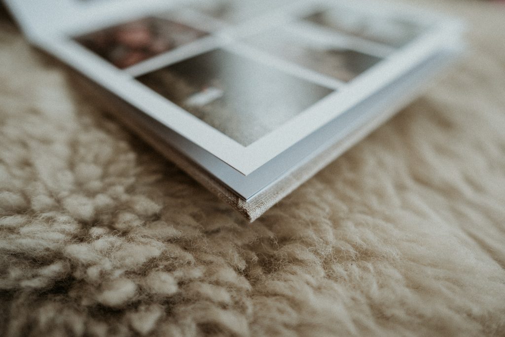 Lume Storybook, a natural linen hardcover photo book featuring images in a storytelling format and layflat pages. Corner detail.